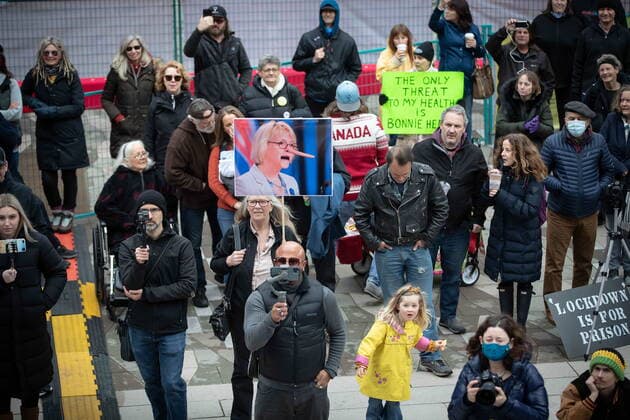 February 20, 2021, Vancouver, BC, Canada: A woman holds a photograph of B.C. Provincial Health Officer Dr. Bonnie Henry stylized as Pinocchio as people opposed to public health measures to curb the spread of COVID-19 attend the B.C. Grand Freedom Rally, in Vancouver, on Saturday, February 20, 2021. Vancouver Canada  - ZUMAc35_ 20210220_zaf_c35_041 Copyright: xDarrylxDyckx
