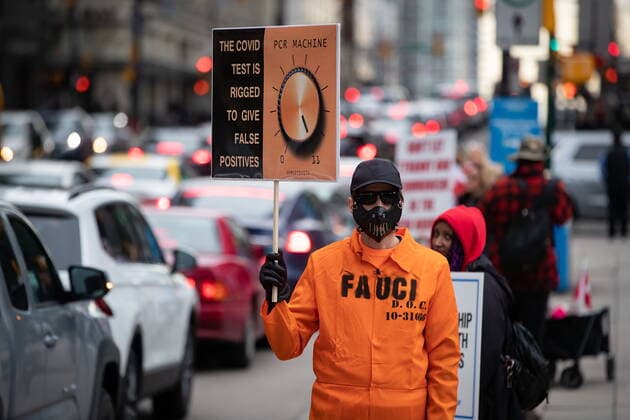 February 20, 2021, Vancouver, BC, Canada: A person in a makeshift prison jumpsuit bearing the last name of Dr. Anthony Fauci holds a sign about PCR testing as people opposed to public health measures to curb the spread of COVID-19 attend the B.C. Grand Freedom Rally, in Vancouver, on Saturday, February 20, 2021. Vancouver Canada  - ZUMAc35_ 20210220_zaf_c35_042 Copyright: xDarrylxDyckx