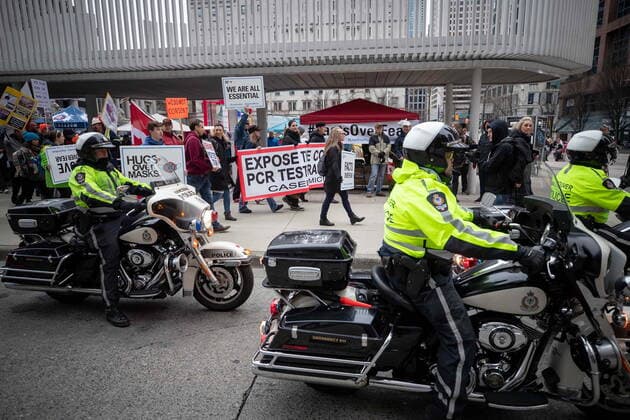 February 20, 2021, Vancouver, BC, Canada: People opposed to public health measures to curb the spread of COVID-19 are given a police escort as they march after the B.C. Grand Freedom Rally, in Vancouver, on Saturday, February 20, 2021. Vancouver Canada  - ZUMAc35_ 20210220_zaf_c35_043 Copyright: xDarrylxDyckx