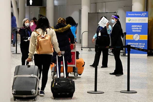 February 22, 2021, Toronto, on, Canada: Travellers, who are not affected by new quarantine rules, arrive at Terminal 3 at Pearson Airport in Toronto early Monday, February 22, 2021. Prime Minister Justin Trudeau announced that all travellers entering Canada by air would have to quarantine in a hotel for three days at their own expense starting later today. Toronto Canada  - ZUMAc35_ 20210222_zaf_c35_001 Copyright: xFrankxGunnx
