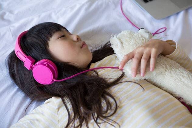 Girl listening to music while resting on bed Girl with stuffed toy listening to music while resting on bed at home, model released, , property released, Cape Town, South Africa, 2017-05-24T23:00:00.000Z, 1054203.jpg, home, house, household, homey, apartment, domicile, abode, lifestyle, leisure, domestic life, bedroom, bed, comforter, comfortable, cozy, relaxation, childhood, innocent, innocence, resting, long hair, bangs, relaxing, laptop, connection, lying down, headphones, listening, music, lying on back, technology, sleeping, eyes closed, stuffed toy, toy, sheet, pink, casual clothing, animal representation Child, Girl, Female, Chinese, 8-9 Years, Girls, Chinese Ethnicity Indoors,Day,Half length