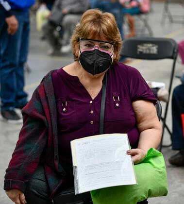 (210223) -- ECATEPEC, Feb. 23, 2021 -- A woman holds a certificate of injection of the COVID-19 vaccine developed by Chinese pharmaceutical company Sinovac at a vaccination site in Ecatepec, Mexico, Feb. 22, 2021. Mexican health authorities on Monday began to vaccinate older adults with a COVID-19 vaccine developed by Chinese pharmaceutical company Sinovac, after a shipment of doses arrived on Saturday. Mexico s government designated the first shipment of the Sinovac vaccine to arrive in Ecatepec, a city in central State of Mexico that lies on the outskirts of the capital Mexico City. Early in the day, brigades of healthcare workers began to administer the vaccine to hundreds of residents aged 60 and over who went to the Las Americ 