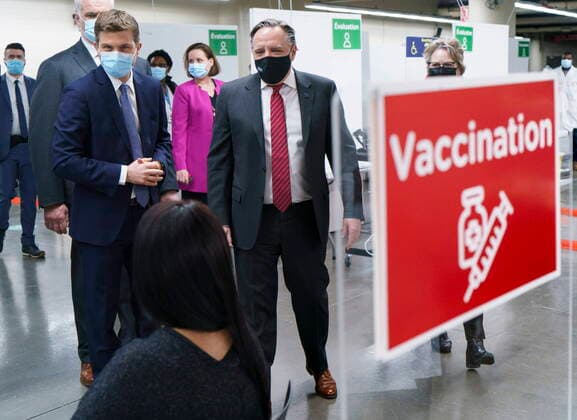 February 23, 2021, Montreal, PQ, Canada: Quebec Premier Francois Legault chats with a woman who just got her COVID-19 vaccine at a clinic in Montreal s Olympic Stadium on Tuesday, February 23, 2021. Montreal Canada  - ZUMAc35_ 20210223_zaf_c35_043 Copyright: xPaulxChiassonx