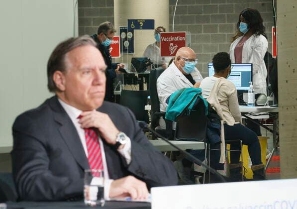 February 23, 2021, Montreal, PQ, Canada: Quebec Premier Francois Legault listens to a question during a new conference in a COVID-19 vaccination clinic at Montreal s Olympic Stadium on Tuesday, February 23, 2021. Montreal Canada  - ZUMAc35_ 20210223_zaf_c35_051 Copyright: xPaulxChiassonx