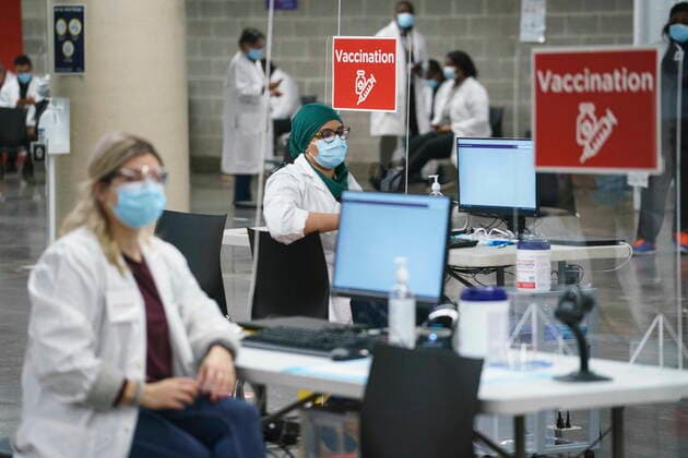 February 23, 2021, Montreal, PQ, Canada: Health-care workers wait for patients at a COVID-19 vaccination clinic in Montreal s Olympic Stadium on Tuesday, February 23, 2021. Montreal Canada  - ZUMAc35_ 20210223_zaf_c35_062 Copyright: xPaulxChiassonx