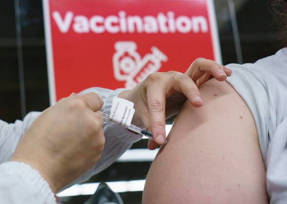 February 23, 2021, Montreal, PQ, Canada: A woman receives her COVID-19 vaccine at a vaccination clinic in Montreal s Olympic Stadium on Tuesday, February 23, 2021. Montreal Canada  - ZUMAc35_ 20210223_zaf_c35_063 Copyright: xPaulxChiassonx