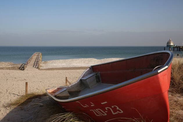 View on Tuesday 23 02 2021 in the Baltic Sea health resort Zingst district Vorpommern Rügen on the local beach In Mecklenburg Vorpommern prevail in some places already summery temperatures Nevertheless the snow of the last weeks has not thawed at all beach sections of the country for a long time Thus numerous Baltic Sea resorts invite at present to a