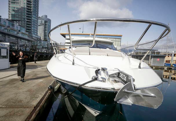 (210224) -- VANCOUVER, Feb. 24, 2021 -- A cruiser boat for display during the 2021 Vancouver International Boat Show is seen at a harbour in Vancouver, British Columbia, Canada, Feb. 24, 2021. The Vancouver International Boat Show which goes virtual this year due to the COVID-19 pandemic, kicked off on Wednesday, showcasing hundreds of new boats, products and accessories online. (Photo by Xinhua) CANADA-VANCOUVER-INTERNATIONAL BOAT SHOW LiangxSen 