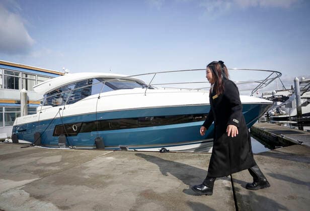 (210224) -- VANCOUVER, Feb. 24, 2021 -- A show organizer walks past a boat for display during the 2021 Vancouver International Boat Show, at a harbour in Vancouver, British Columbia, Canada, Feb. 24, 2021. The Vancouver International Boat Show which goes virtual this year due to the COVID-19 pandemic, kicked off on Wednesday, showcasing hundreds of new boats, products and accessories online. (Photo by Xinhua) CANADA-VANCOUVER-INTERNATIONAL BOAT SHOW LiangxSen