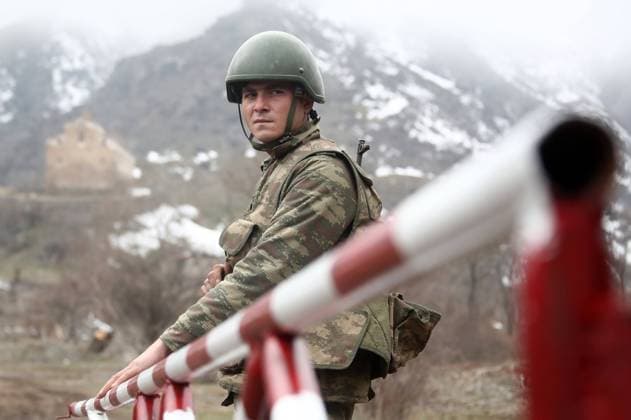 AZERBAIJAN - FEBRUARY 24, 2021: A serviceman at an Azerbaijani military outpost by the Agaoglan Monastery in Lachin District. The fighting between Armenia and Azerbaijan over the disputed Caucasus Mountains territory of Nagorno-Karabakh resumed in late September; on November 9, Armeniaâ€™s Prime Minister Nikol Pashinyan, Russiaâ€™s President Vladimir Putin, and Azerbaijanâ€™s President Ilham Aliyev signed a trilateral statement on a complete ceasefire in Nagorno-Karabakh. The agreement also provides for the deployment of a Russian peacekeeping mission along the contact line and the Lachin Corridor mountain pass. Valery Sharifulin TASS  TS0F7ABC