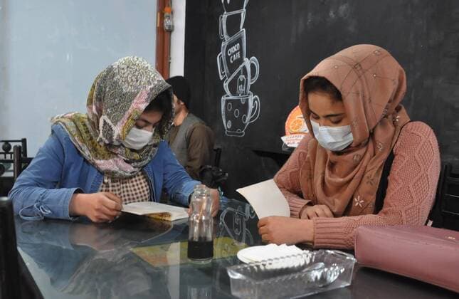 (210227) -- SHIERGHAN, Feb. 27, 2021 -- Afghan girls read books at a coffee shop managed by Malalai Mobariz in Shiberghan, capital of Jawzjan province, Afghanistan, Feb. 20, 2021. In militancy-plagued Afghanistan, it is not easy for women to run their own businesses, but Malalai Mobariz is among a handful of women who confronted the challenges and opened a coffee shop in the country s northern Shiberghan city. TO GO WITH Feature: Afghan women runs coffee shop with resilience, hard work and courage (Photo by Xinhua) AFGHANISTAN-JAWZJAN-COFFEE SHOP-WOMEN MohammadxJanxAria 