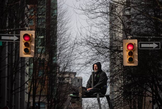 February 27, 2021, Vancouver, BC, Canada: A person sits on a tripod platform high above the street as protesters occupy an intersection during an Extinction Rebellion demonstration to call for government action to address the climate and ecological crisis, in Vancouver, on Saturday, February 27, 2021. Vancouver Canada  - ZUMAc35_ 20210227_zaf_c35_080 Copyright: xDarrylxDyckx