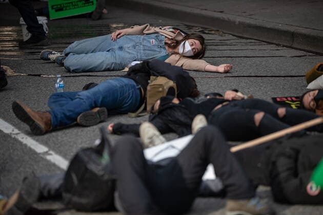 February 27, 2021, Vancouver, BC, Canada: People lie on the ground while taking part in a die-in after members of Extinction Rebellion spilled red liquid representing blood on the street outside B.C. Supreme Court as part of a theatrical demonstration of mourning, during a protest to call for government action to address the climate and ecological crisis, in Vancouver, on Saturday, February 27, 2021. Vancouver Canada  - ZUMAc35_ 20210227_zaf_c35_084 Copyright: xDarrylxDyckx