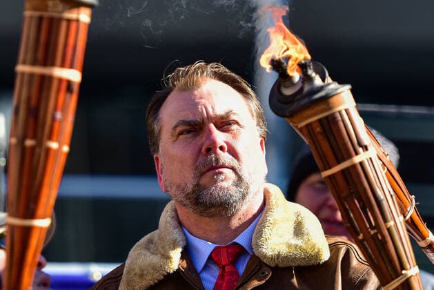 February 27, 2021, Calgary, Alberta, Canada: Preacher Artur Pawlowski lights a tiki torch during the anti-mask protest Freedom March in Calgary, AB on Feb 27, 2021. The march was lead by people carrying tiki torches said to signify the light of the lord but also reminiscent of the Charlottesville Unite the Right rally in 2017. Calgary Canada - ZUMAj113 20210227_zip_j113_008 Copyright: xGavinxJohnx