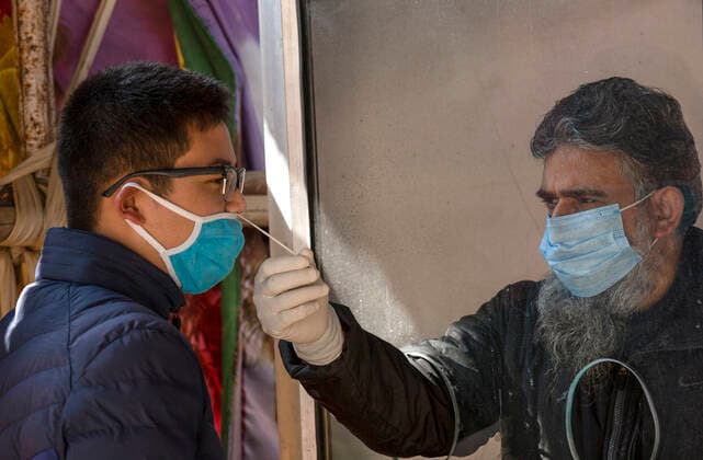 (210228) -- SRINAGAR, Feb. 28, 2021 -- A health worker takes a nasal swab sample from a boy to test with Rapid Antigen Test (RAT) for the COVID-19 in Srinagar city, the summer capital of Indian-controlled Kashmir, Feb. 28, 2021. ) KASHMIR-SRINAGAR-COVID-19 JavedxDar 