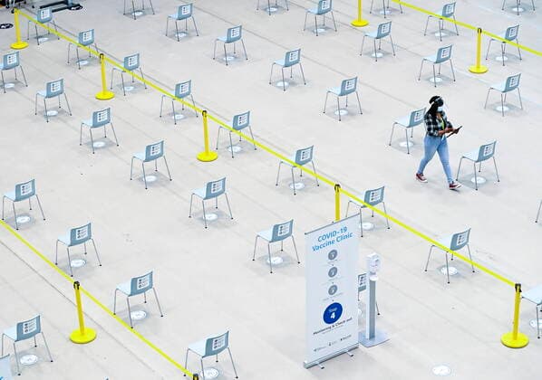 March 1, 2021, Mississauga, on, Canada: A worker walks through the post vaccine waiting area at a mass COVID-19 vaccination clinic for Peel Region during the COVID-19 pandemic in Mississauga, Ont., on Monday, March 1, 2021. Mississauga Canada  - ZUMAc35_ 20210301_zaf_c35_046 Copyright: xNathanxDenettex