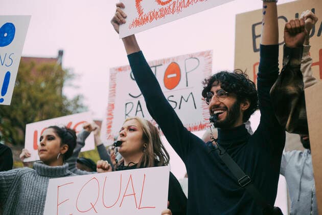 Smiling man with female activists protesting in social movement Sweden, Stockholm, model released Copyright: xMaskotx , MA84452