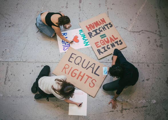Directly above of male and female activist preparing posters for social issues during pandemic Sweden, Stockholm, model released, property released Copyright: xMaskotx , MA84461