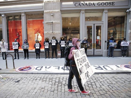 PETA protesters wearing skull masks and fake Canada Goose coats holds signs at a protest outside of a Canada Goose retail store in New York City on Wednesday, March 3, 2021. The protest is part of a week of action that will also include Canada Goose protests in Beverly Hills, California, Boston and Pittsburgh.  NYP20210303105A JohnxAngelillo