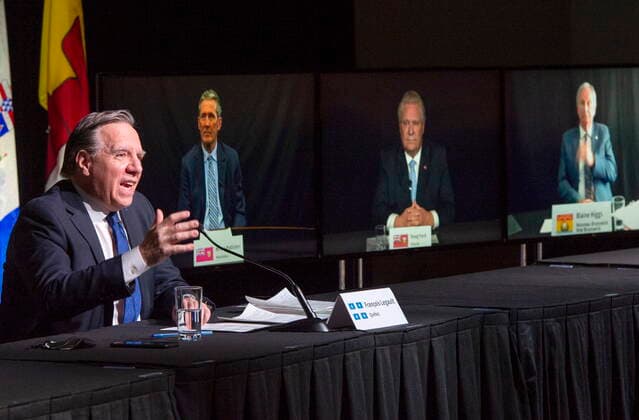 March 4, 2021, Montreal, PQ, Canada: Quebec Premier Francois Legault chairs a premiers virtual news conference as premiers Brian Pallister, Manitoba, Doug Ford, Ontario and Blaine Higgs, New Brunswick are seen on screen, Thursday, March 4, 2021 in Montreal. Montreal Canada  - ZUMAc35_ 20210304_zaf_c35_037 Copyright: xRyanxRemiorzx