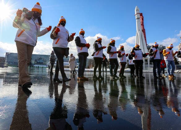 MOSCOW, RUSSIA â€“ MARCH 5, 2021: Volunteers of the My Vmeste initiative form a human chain and pass on a ball of orange thread, the initiativeâ€™s logo, during a flashmob in VDNKh to celebrate the first anniversary of the initiative. My Vmeste We Are Together , a community of volunteers who provide assistance to the elderly, disabled people, health workers, NGO social workers and other people in need during the COVID-19 pandemic. The MyVmeste office opened in Moscow on 28 March 2020. Volunteers have been helping people in self isolation during the lockdown and after by delivering groceries, medicines and other essentials. Vladimir Gerdo TASS  TS0F899F