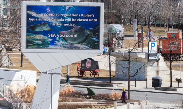 (210305) -- TORONTO, March 5, 2021 -- A woman walks past the closed Ripley s Aquarium of Canada in Toronto, Canada, on March 5, 2021. The global COVID-19 pandemic, including the associated restrictions and lockdowns over the past 12 months, have resulted in 8.35 billion Canadian dollars (about 6.6 billion U.S. dollars) in lost economic activity from visitor spending in Toronto, according to a press release by Destination Toronto on Thursday. (Photo by Xinhua) CANADA-TORONTO-COVID-19-TOURISM ZouxZheng 
