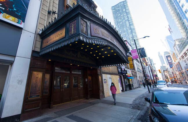 (210305) -- TORONTO, March 5, 2021 -- A woman wearing a face mask walks past a closed theater in Toronto, Canada, on March 5, 2021. The global COVID-19 pandemic, including the associated restrictions and lockdowns over the past 12 months, have resulted in 8.35 billion Canadian dollars (about 6.6 billion U.S. dollars) in lost economic activity from visitor spending in Toronto, according to a press release by Destination Toronto on Thursday. (Photo by Xinhua) CANADA-TORONTO-COVID-19-TOURISM ZouxZheng 