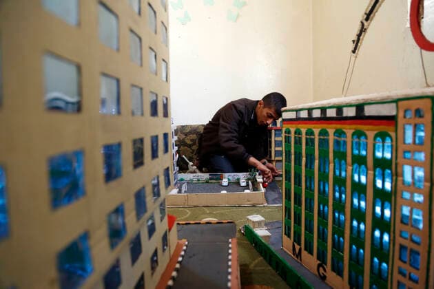 (210306) -- SANAA, March 6, 2021 -- Musheer Al-Hzmi, makes building models inside his house in Sanaa, Yemen, on March 4, 2021. TO GO WITH Feature: Yemeni boy makes building models to recreate Sanna before war (Photo by Xinhua) YEMEN-SANAA-BUILDING MODELS MohammedxMohammed 