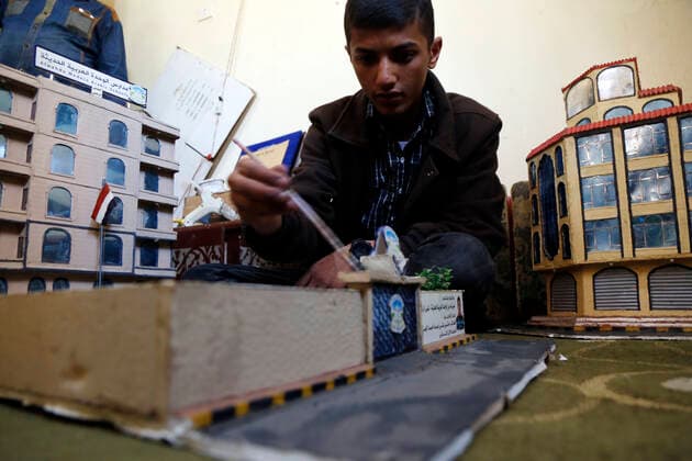 (210306) -- SANAA, March 6, 2021 -- Musheer Al-Hzmi, makes building models inside his house in Sanaa, Yemen, on March 4, 2021. TO GO WITH Feature: Yemeni boy makes building models to recreate Sanna before war (Photo by Xinhua) YEMEN-SANAA-BUILDING MODELS MohammedxMohammed 