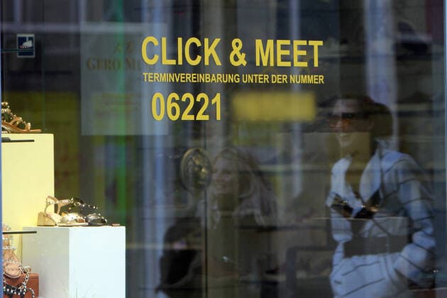 Lettering Click Meet Appointment sticker on a closed fashion store in the pedestrian zone and shopping street Hauptstraße in downtown Heidelberg, Baden Württemberg, Germany