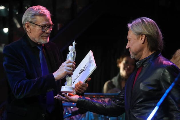 ST PETERSBURG, RUSSIA - MARCH 8, 2021: Actor Dmitry Kharatyan (R) presents the award For Serving the Russian Repertory Theater to actor Alexander Mikhailov at the 11th Andrei Mironov Figaro Russian National Acting Award ceremony at Andrei Mironov Russian Enterprise Theater. Alexander Demianchuk TASS  TS0F8E11