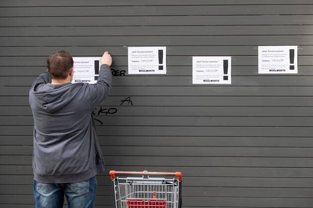 (210309) -- BERLIN, March 9, 2021 -- A shop assistant puts up signs of booking appointments for shopping in Berlin, Germany, on March 9, 2021. Stores in Berlin were allowed to reopen with hygienic requirements and restrictions on Tuesday. (Photo by Xinhua) GERMANY-BERLIN-COVID-19-STORES-REOPENING StefanxZeitz 