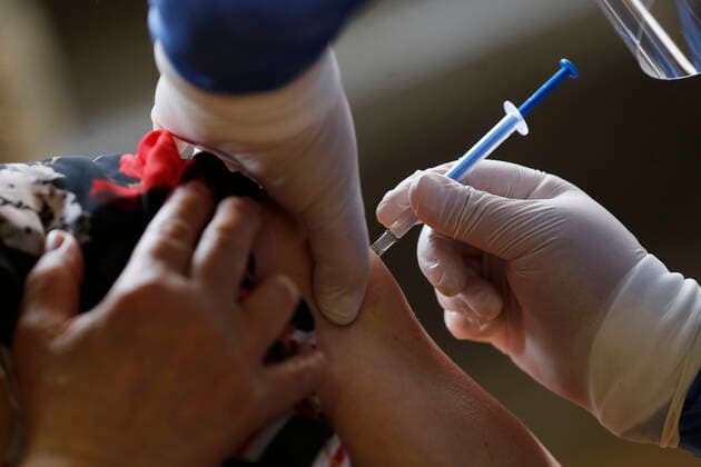 March 10, 2021, Uruapan, Michoacan, Mexico: A person receives a dose of Pfizer-BioNTech Covid-19 vaccine before inject to an elderly, during mass vaccine inside of Hermanos Lopez Rayon sports center, a designated priority vaccination center for elderly over 60 years in the Uruapan town. On March 10, 2021 in Michoacan, Mexico. Uruapan Mexico - ZUMAe321 20210310_zia_e321_004 Copyright: xCarlosxGuzmanx
