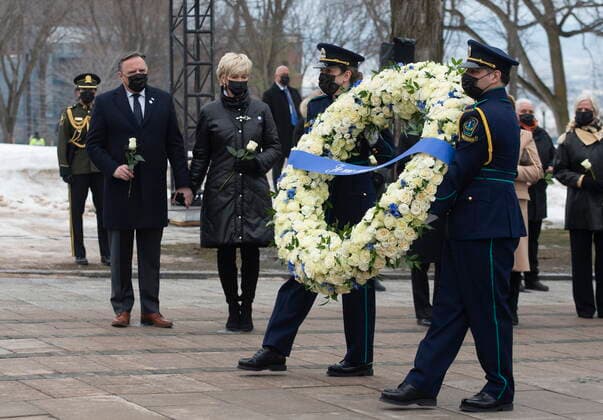 March 11, 2021, QUEBEC, PQ, Canada: Health workers carry a wreath as Quebec Premier Francois Legault, left, and his wife Isabelle Brais look on during a ceremony for the victims of COVID-19, Thursday, March 11, 2021 at the legislature in Quebec City. QUEBEC Canada  - ZUMAc35_ 20210311_zaf_c35_043 Copyright: xJacquesxBoissinotx