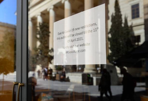 (210311) -- VALLETTA, March 11, 2021 -- A notice of closure is seen on a store in Valletta, Malta, March 11, 2021. The Maltese government on Wednesday announced the closure of schools and non-essential shops in response to a spike in new COVID-19 cases, almost two-thirds of which are attributable to the variant first reported in the UK. The new measures, which will be in force until April 11, include the closure of all non-essential shops and those providing non-essential services such as hairdressers and beauticians while the limitation of group gatherings in public down to a maximum of four people. (Photo by Xinhua) MALTA-VALLETTA-COVID-19-RESTRICTIONS JonathanxBorg 
