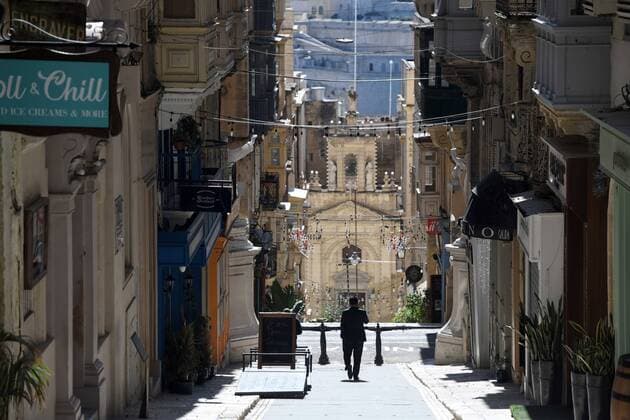 (210311) -- VALLETTA, March 11, 2021 -- A man walks on an empty street in Valletta, Malta, March 11, 2021. The Maltese government on Wednesday announced the closure of schools and non-essential shops in response to a spike in new COVID-19 cases, almost two-thirds of which are attributable to the variant first reported in the UK. The new measures, which will be in force until April 11, include the closure of all non-essential shops and those providing non-essential services such as hairdressers and beauticians while the limitation of group gatherings in public down to a maximum of four people. (Photo by Xinhua) MALTA-VALLETTA-COVID-19-RESTRICTIONS JonathanxBorg 