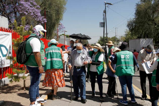 MEXICO CITY, MEXICO - MARCH 11: Staff of various social programmes, support to elderly over to move in wheelchairs to arrive at the facilities of the Autonomous Metropolitan University Azcapotzalco, where health workers apply the Pfizer BioNTech Covid19 vaccine to adults over 60 years of age, in the Third Stage of Vaccination. On March 11, 2021 in in Mexico City, Mexico.. Credit: Luis Barron Eyepix Group The Photo Access Increased COVID Vaccination for Elderly in Mexico  Copyright: xLuisxBarronx