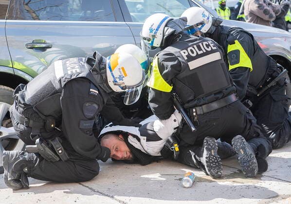 News Bilder des Tages March 13, 2021, Montreal, PQ, Canada: A man is detained by police during a demonstration to oppose government restrictions to curb the spread of Covid-19 in Montreal, Saturday, March 13, 2021, as the COVID-19 pandemic continues in Canada and around the world. Montreal Canada  - ZUMAc35_ 20210313_zaf_c35_009 Copyright: xGrahamxHughesx