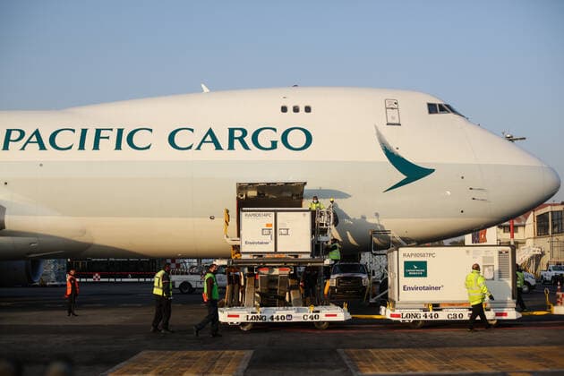 (210314) -- MEXICO CITY, March 14, 2021 -- Staff members unload containers of the COVID-19 vaccine from the Chinese pharmaceutical company Sinovac at the Mexico City s international airport in Mexico, March 13, 2021. The third shipment of the COVID-19 vaccine from the Chinese pharmaceutical company Sinovac arrived Saturday at the Mexico City s international airport. (Photo by Xinhua) MEXICO-VACCINES FROM CHINA-ARRIVAL FranciscoxCanedo 