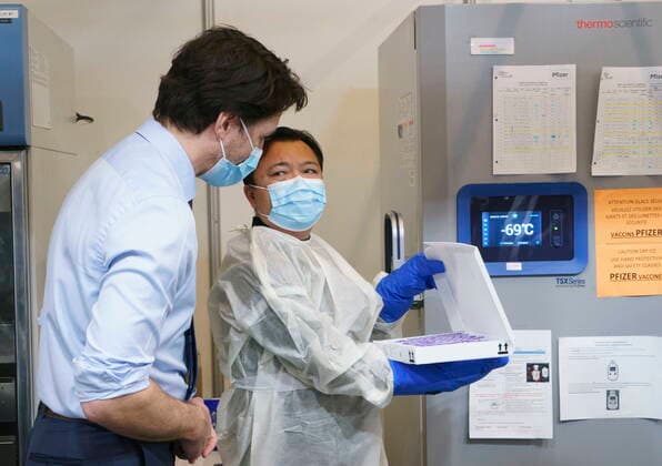 March 15, 2021, Montreal, PQ, Canada: Prime Minister Justin Trudeau looks at a lot of COVID-19 vaccine vials removed from the freezer as he tours a vaccination clinic in Montreal, on Monday, March 15, 2021. Montreal Canada  - ZUMAc35_ 20210315_zaf_c35_009 Copyright: xPaulxChiassonx