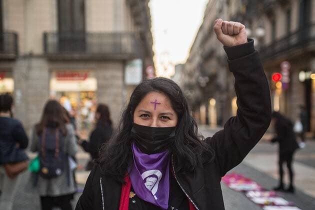 March 15, 2021, Barcelona, Spain: A woman with a cross on her forehead holds up her fist during the demonstration..The collective of Mexican women in Barcelona, Mexican Fury (Furia Mexicana) have convened in front of the town hall as they protest against feminicide and sexist violence in Mexico and paid tribute to various victims of feminicide in Mexico in the last year. Barcelona Spain - ZUMAs197 20210315_zaa_s197_127 Copyright: xThiagoxPrudenciox