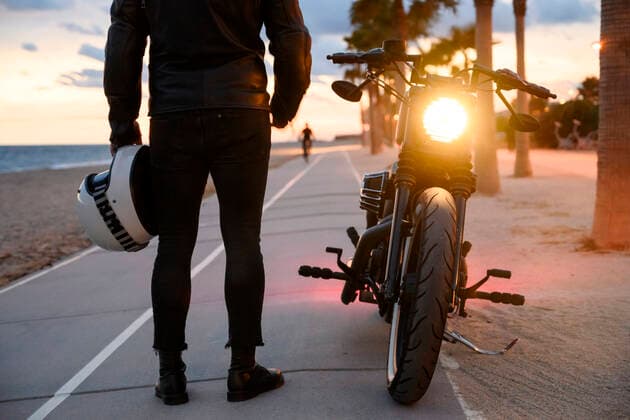 Young man standing near motorbike and enjoying sunset view Teià, CT, Spain CR_RAFE210315-648500-01 ,model released, Symbolfoto