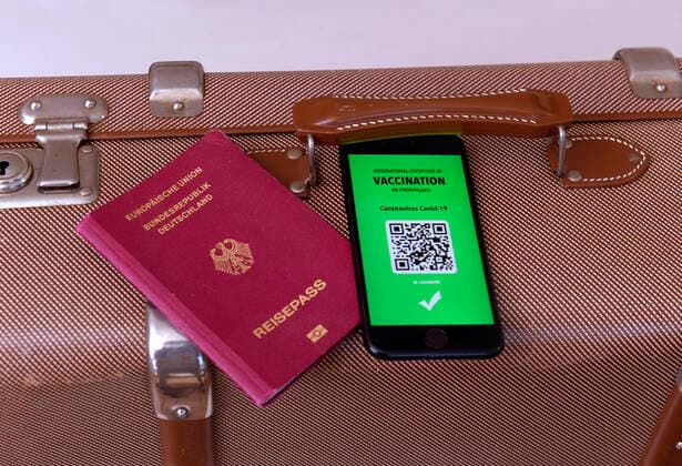 17 03 2021, Symbolic image, Vaccination An imaginary vaccination certificate in digital form on the smartphone iPhone, placed at the ready on a travel case with a passport The digital vaccination certificate would once again enable unrestricted travel, 17 03 2021, Electronic vaccination certificate for holiday travel 17 03 2021, Electronic vaccination certificate for holiday travel