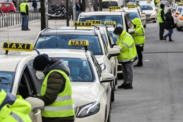 (210320) -- BERLIN, March 20, 2021 -- Staff members help taxi drivers register as they arrive for picking up passengers near a COVID-19 vaccination site in Berlin, capital of Germany, March 19, 2021. Germany s reported daily COVID-19 infections continued to rise sharply on Friday as the country registered 17,482 new cases in one day, the Robert Koch Institute (RKI) said on Friday. (Photo by Xinhua) GERMANY-BERLIN-COVID-19-CASES StefanxZeitz 