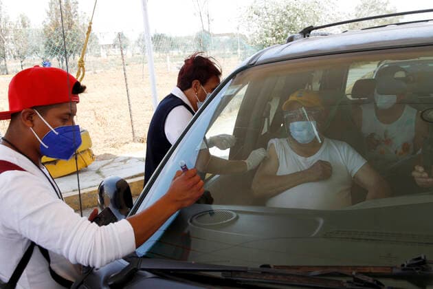 Sinovac Vaccine Is Applied To Older Adults In Their Cars In Mexico NEZAHUALCOYOTL CITY, MEXICO - MARCH 19: A health worker, injects a Sinovac Covid19 vaccine to an elderly while a man marks the car at the Sports City Garden, in the municipality of Nezahualcoyotl in the State of Mexico, during a immunization program to drivers against Covid19. On March 19, 2021 in Nezahualcoyotl City, Mexico. Copyright: xLuisxBarronx EYEPIXGROUP_LB_19032021_5106