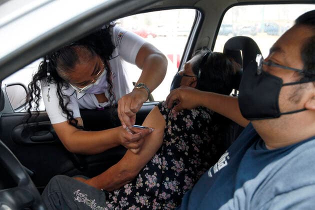 March 19, 2021, Nezahualcoyotl City, State Of Mexico, Mexico: A health worker, injects a Sinovac Covid19 vaccine to an elderly inside a car at the Sports City Garden, in the municipality of Nezahualcoyotl in the State of Mexico, during a immunization program to drivers against Covid19. On March 19, 2021 in Nezahualcoyotl City, Mexico. Nezahualcoyotl City Mexico - ZUMAe321 20210319_zia_e321_008 Copyright: xLuisxBarronx
