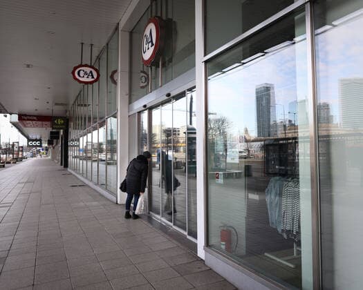 (210320) -- WARSAW, March 20, 2021 -- A woman looks through the window of a closed shop in central Warsaw, Poland, on March 20, 2021. The government of Poland announced a new nationwide partial lockdown on Friday after the cumulative number of COVID-19 cases since the start of the pandemic exceeded two million in the country. Starting on Saturday, only a select number of shops -- among them supermarkets and pharmacies -- located in shopping malls with over 2,000 square meters of retail space are allowed to operate. Cinemas, theaters and museums will have to remain closed, and schools will return to online learning. (Photo by Xinhua) POLAND-WARSAW-COVID-19-PARTIAL LOCKDOWN JaapxArriens 