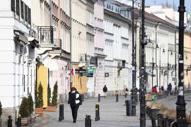 (210320) -- WARSAW, March 20, 2021 -- A woman wearing a face mask walks on a street in central Warsaw, Poland, on March 20, 2021. The government of Poland announced a new nationwide partial lockdown on Friday after the cumulative number of COVID-19 cases since the start of the pandemic exceeded two million in the country. Starting on Saturday, only a select number of shops -- among them supermarkets and pharmacies -- located in shopping malls with over 2,000 square meters of retail space are allowed to operate. Cinemas, theaters and museums will have to remain closed, and schools will return to online learning. (Photo by Xinhua) POLAND-WARSAW-COVID-19-PARTIAL LOCKDOWN JaapxArriens 