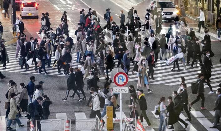 Virus emergency lifting People wearing face masks walk in the rain in Tokyo s Shibuya area on March 21, 2021, ahead of the scheduled lifting of the coronavirus state of emergency at the end of the day. 