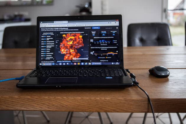 Bamberg, Germany 21 March 2021 On a table in an apartment is an open laptop, on the screen is the page from the Robert Koch Institute with the current COVID 19 case numbers Bayern to see. Copyright: xFotostandx xK.xSchmittx